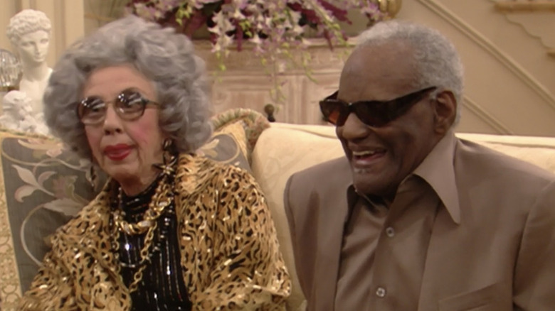 Yetta and Sammy sit on couch