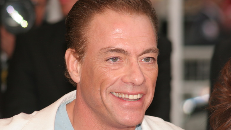 Jean-Claude Van Damme smiling off camera