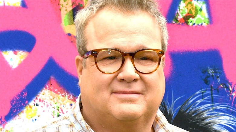Eric Stonestreet smiling with glasses on