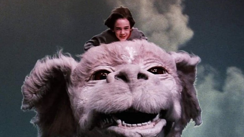 Barrett Oliver as Bastian riding Falkor at the end of 