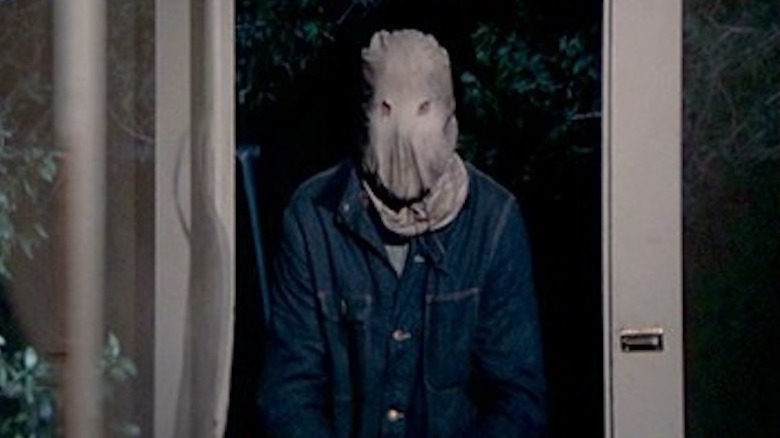 The Phantom standing by the door