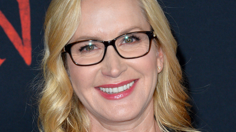 Angela Kinsey in glasses smiling