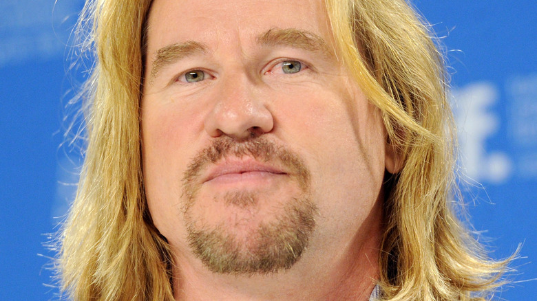 Val Kilmer smirking