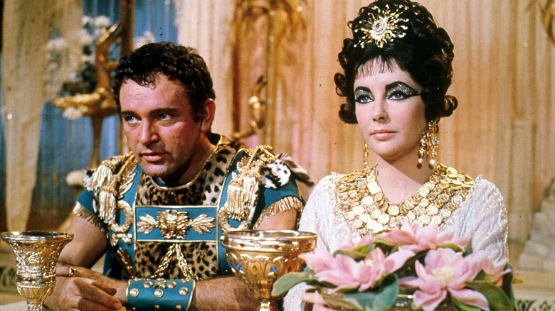 Cleopatra and Mark Antony seated together in opulent finery in "Cleopatra" (1963)