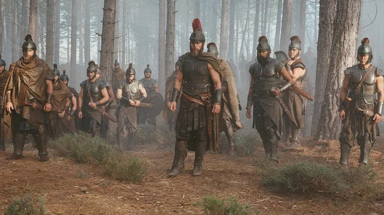 Odysseus and his men walking in the woods in The Odyssey (2026)
