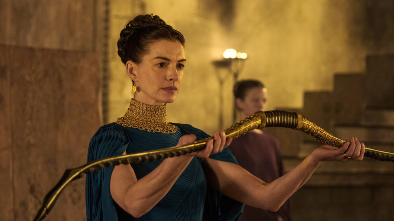 Penelope holding up Odysseus' hunting bow in The Odyssey (2026)