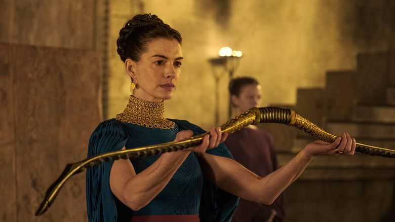 Penelope holding up Odysseus' hunting bow in The Odyssey (2026)