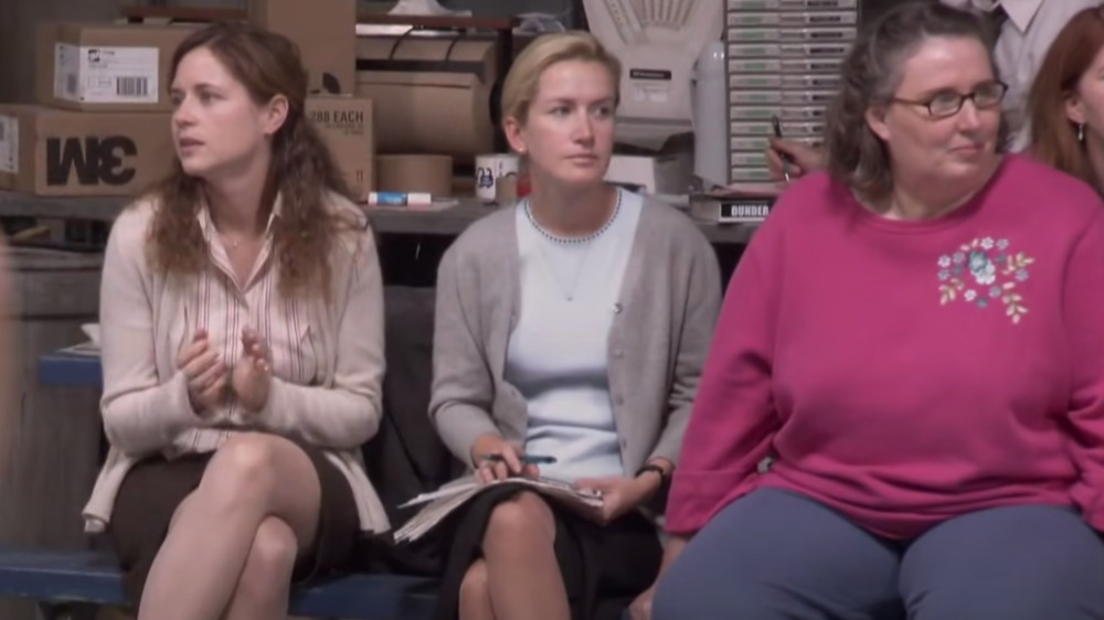 Pam and Angela sitting on sidelines