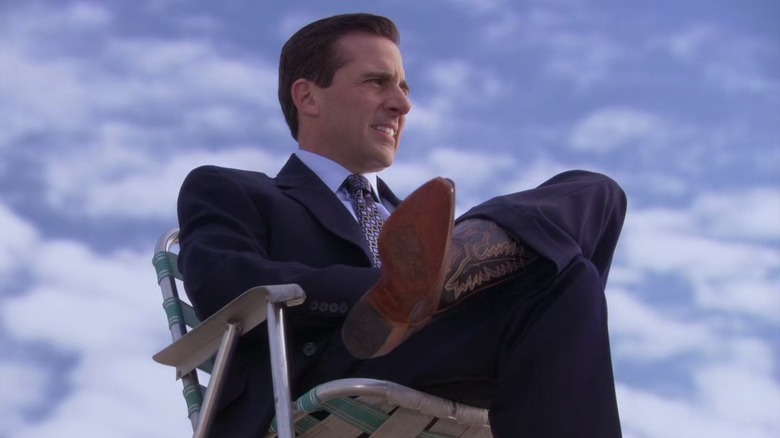 Michael sitting on the office roof in cowboy boots in "Goodbye, Michael" (2011)