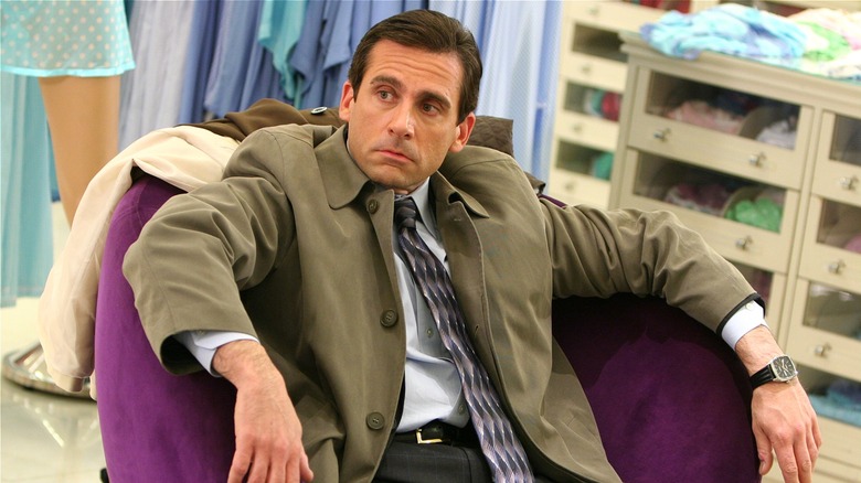 Michael Scott sitting in a chair at the mall on 