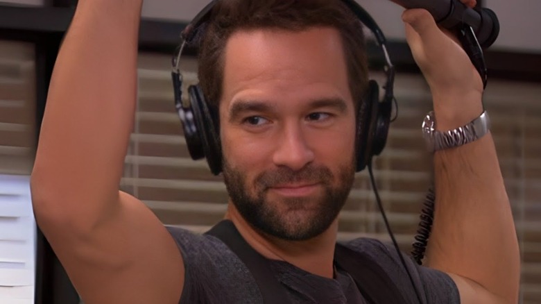 Smiling Brian holds boom mic