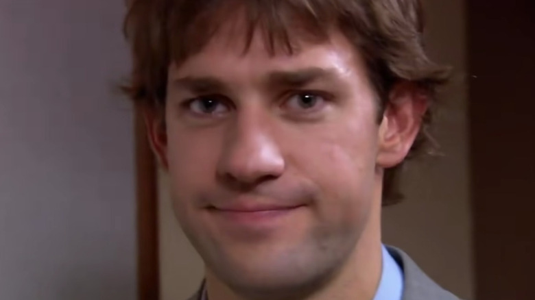 Jim smirks at camera