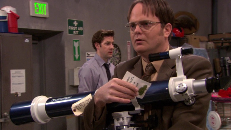 Dwight clutches a telescope