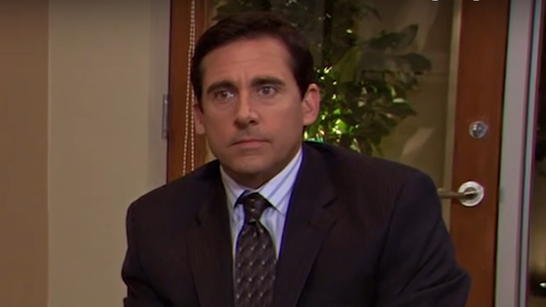 Michael Scott sitting at a desk