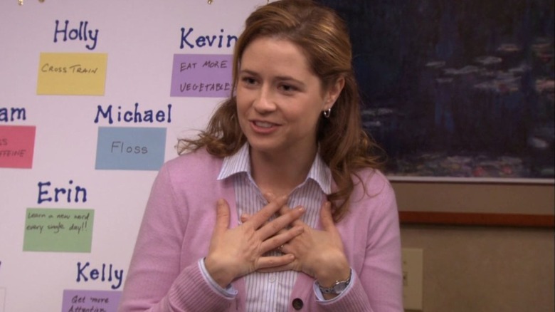 Pam Beesly stands in front of a resolution board in The Office (2011)