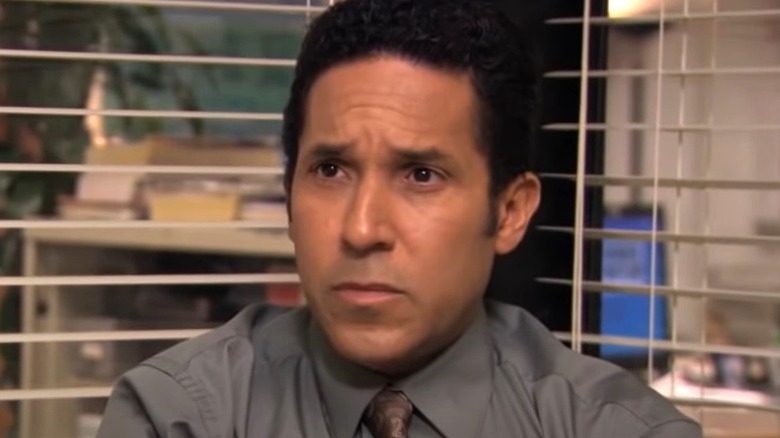 Oscar Martinez looking serious gray shirt