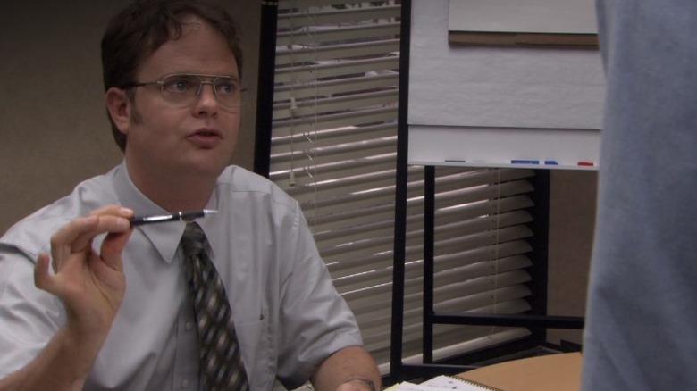Dwight holds a pen