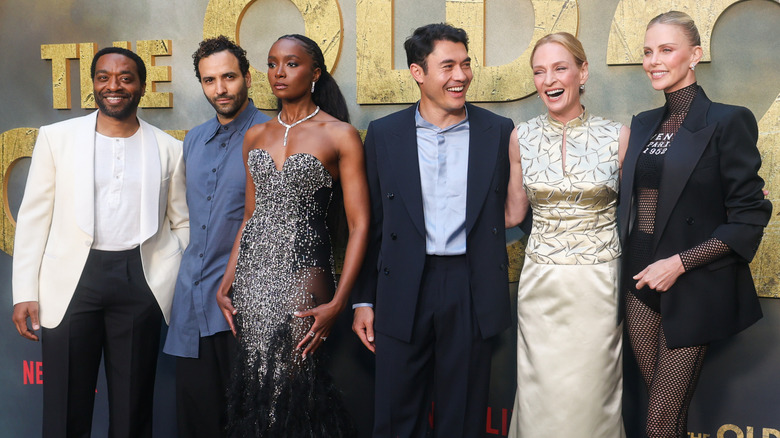 The cast of "The Old Guard 2" pose on the red carpet