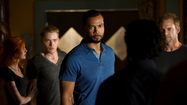 Clary, Jace, Luke, and Michael looking at someone in Shadowhunters