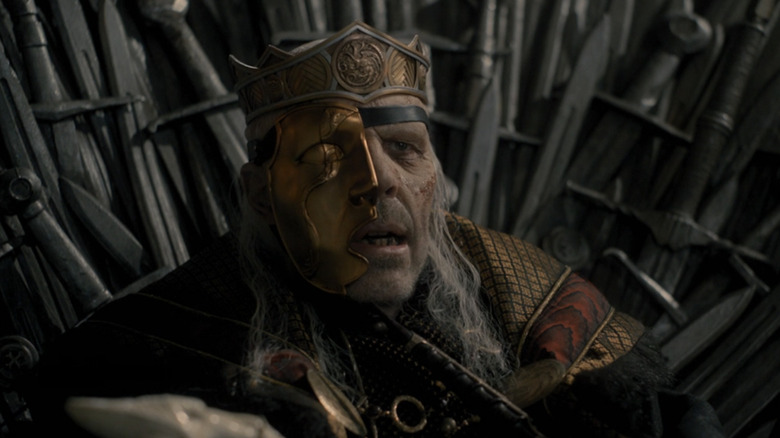 A dying King Viserys sits on the Iron Throne for the last time.