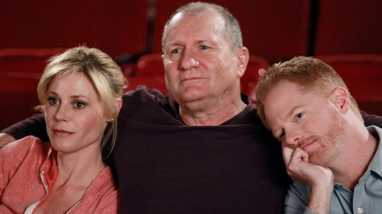 Claire, Jay, and Mitch sitting in a theater on Modern Family