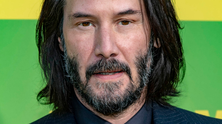 Keanu Reeves smirking at event