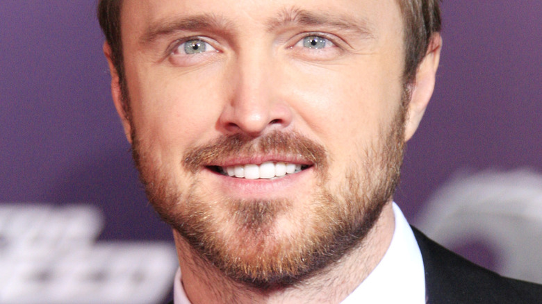 Aaron Paul smiling for camera with blue eyes