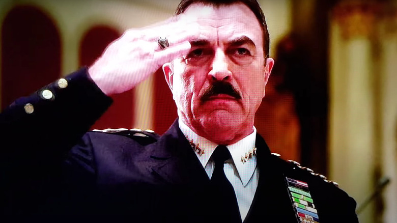 Frank salutes at a funeral