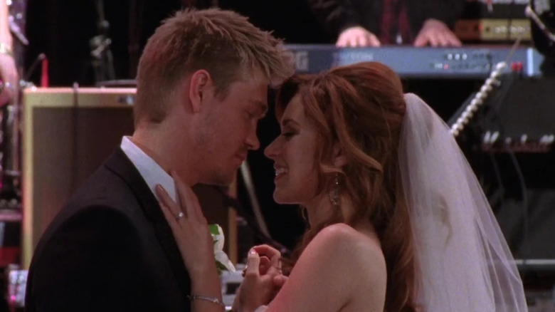 Lucas and Peyton embracing on their wedding day