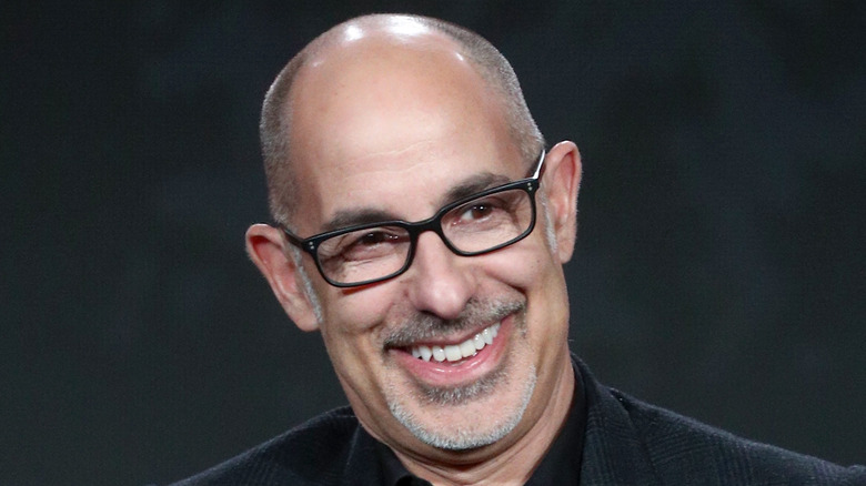 David S. Goyer smiling with glasses