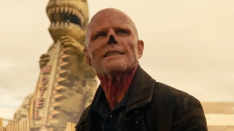 The Ghoul grinning in front of Dinky the Dinonsaur in "Fallout" (2024-present)
