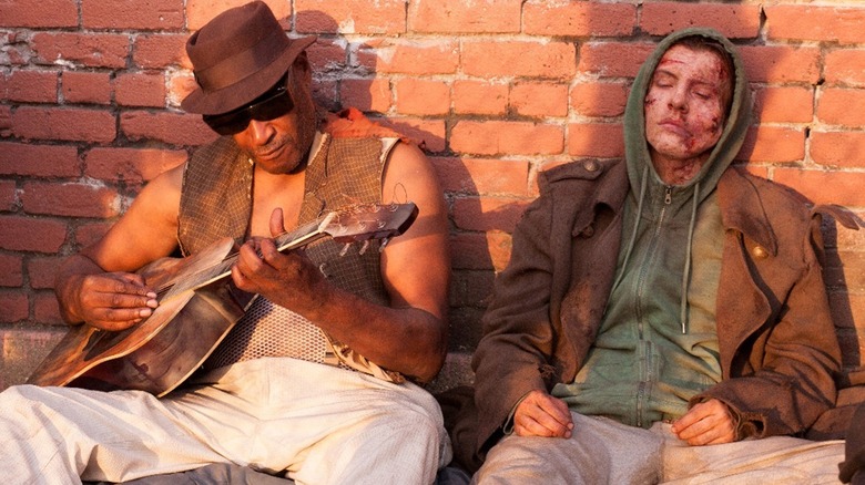 A weary Adam lying in the street in Frankenstein (2015)