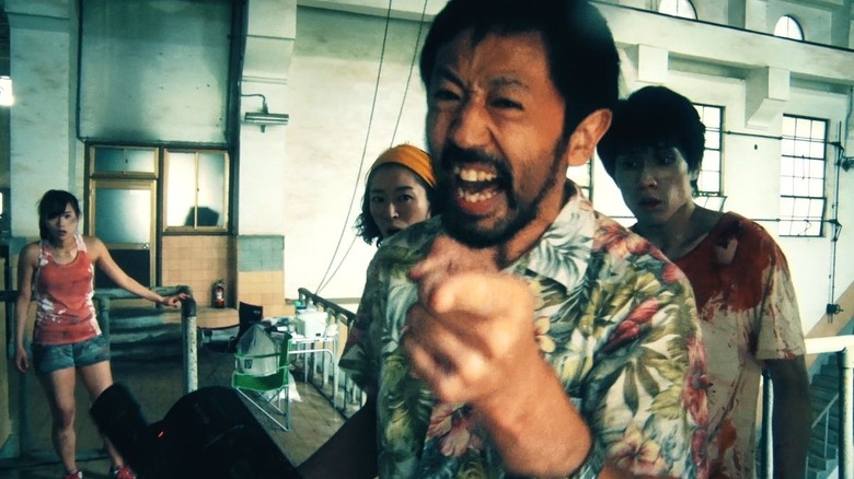 A filmmaker points into the camera in One Cut of the Dead