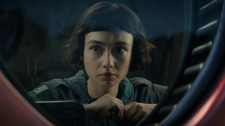 Wendy peering through a window in 