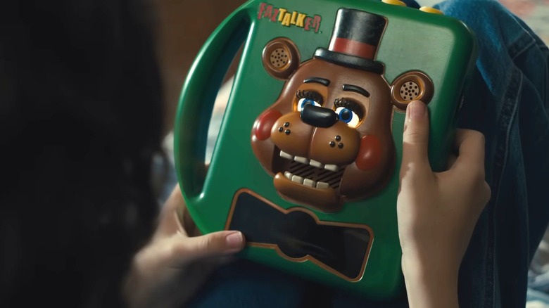 Abby holding a Freddy Fazbear talking box in "Five Nights at Freddy's 2"