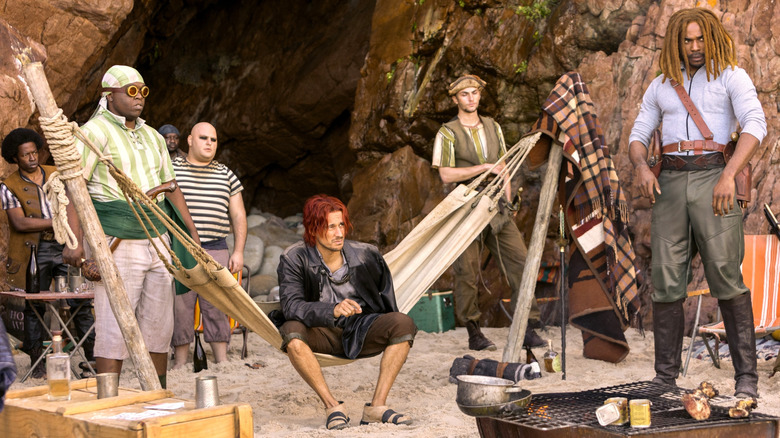 Shanks and the Red Hair Pirates sitting on the beach in One Piece