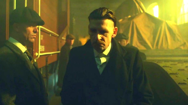 Arthur in the middle of the train heist on Peaky Blinders