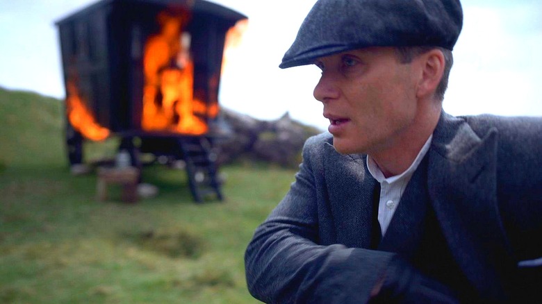 Tommy next to a burning caravan in Peaky Blinders