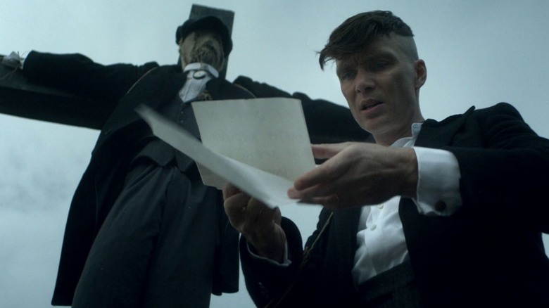 Tommy Shelby reads a warning in Peaky Blinders