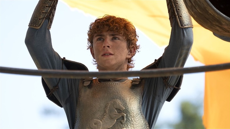 Percy raising hands over his head in 