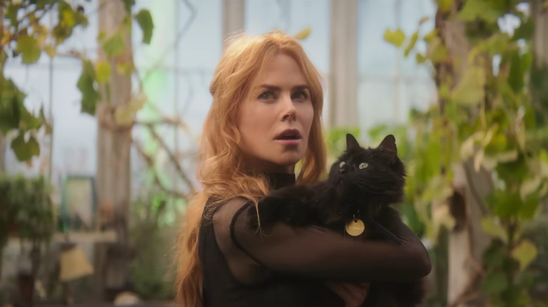 Gillian Owens holding a cat in Practical Magic 2