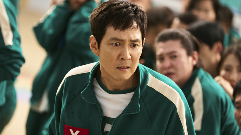 Seong Gi-hun looking troubled in Squid Game