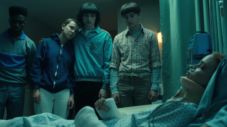 Max in a coma as her friends watch over her in "Stranger Things"