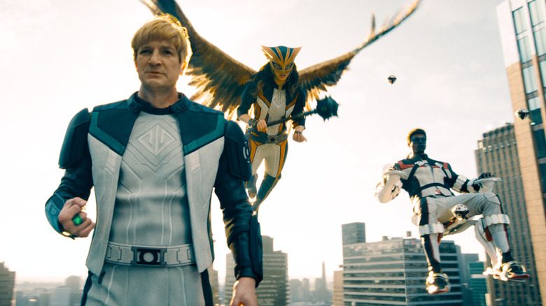 Guy Gardner, Hawkgirl, and Mr. Terrific float above Metropolis in