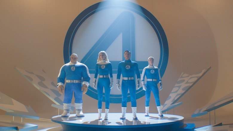 The team stands with their logo in 