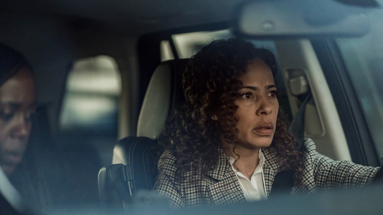 Taissa driving with Simone looking concerned in Yellowjackets