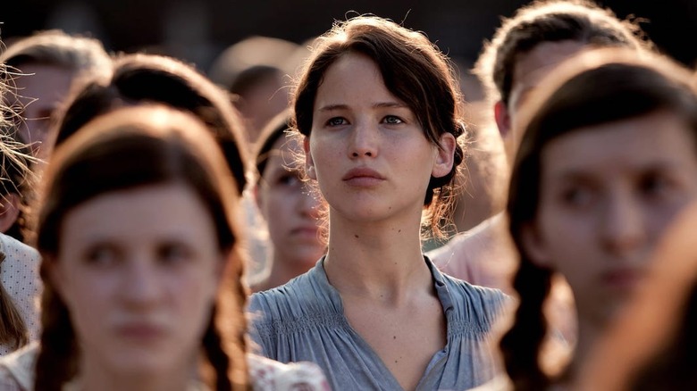 Katniss standing in the District 12 crowd in The Hunger Games