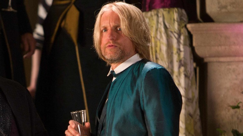 Haymitch in a suit holding a drink in The Hunger Games: Catching Fire