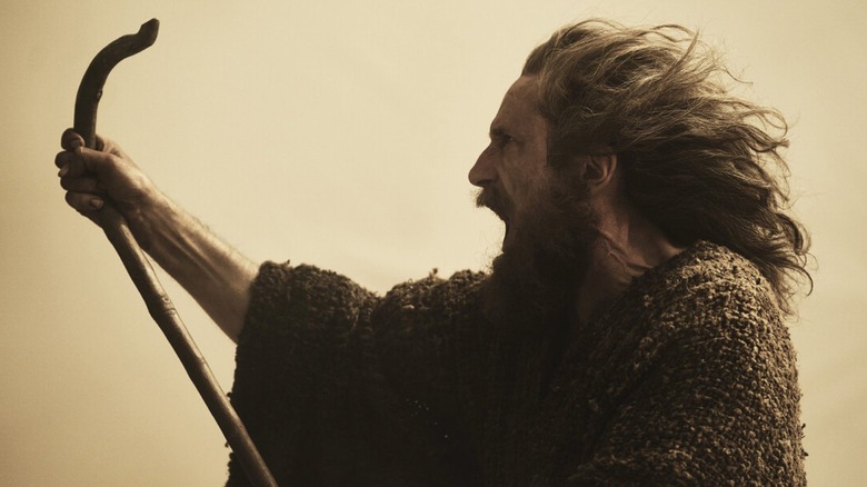 Gandalf raises his staff in a storm in Season 2 of "The Rings of Power" (2022-present)