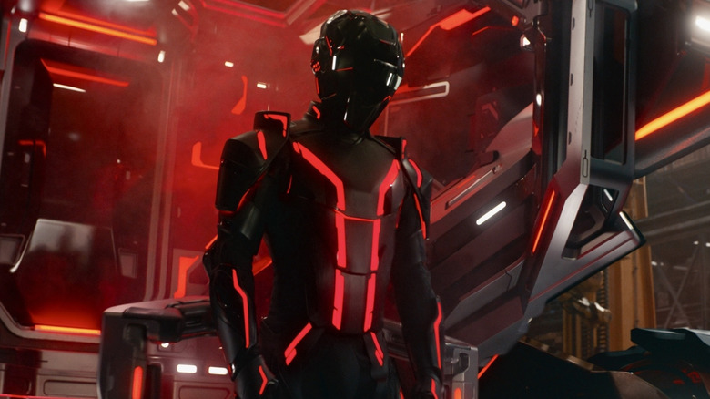 Ares stands beside a lightcycle in 